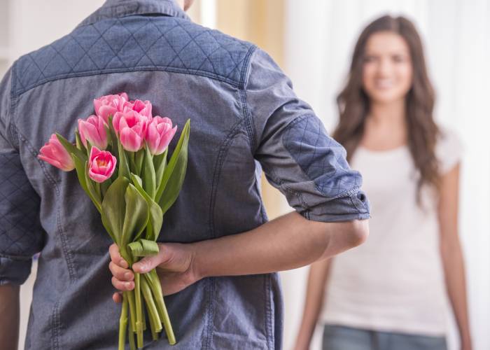 A guy gives a girl a bouquet