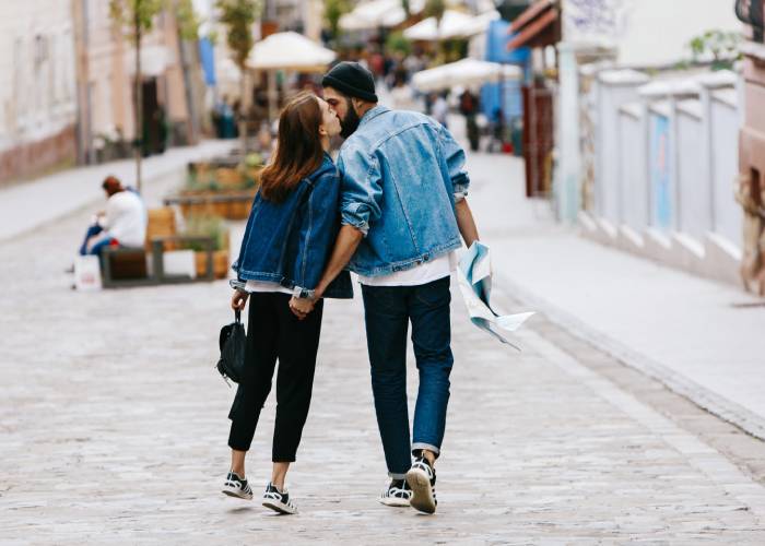 A girl kisses a guy on the cheek