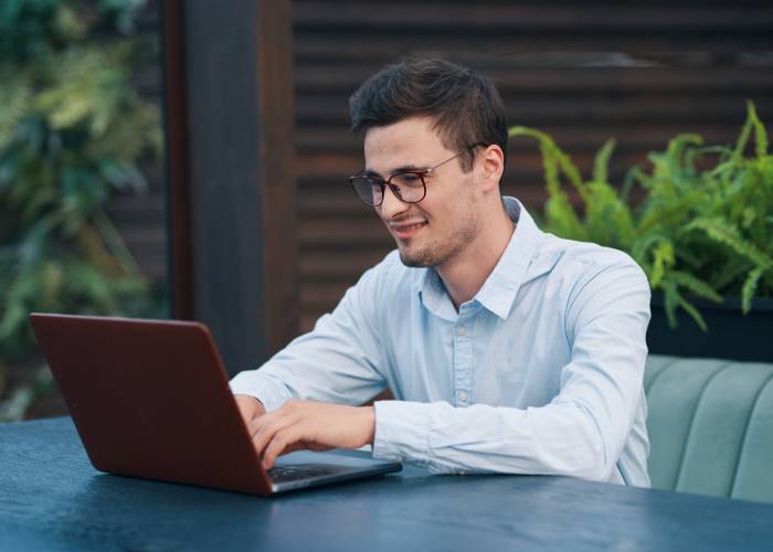 A guy typing on a laptop