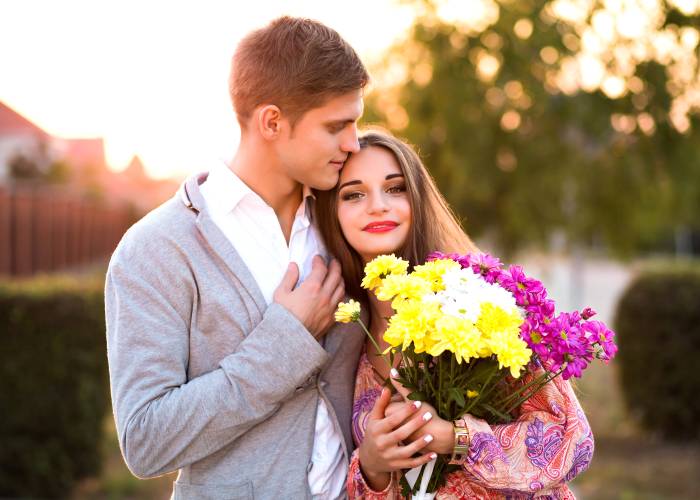 A guy and a girl with a bouquet